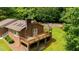 Brick home with large deck featuring a gazebo and outdoor seating, and a backyard swimming pool at 2523 Lovette Ln, Graham, NC 27253
