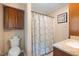 Bathroom featuring a toilet, shower with curtain and sink with vanity at 2523 Lovette Ln, Graham, NC 27253