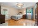Comfortable bedroom with natural light, ceiling fan, and wood floors for a cozy and relaxing space at 2523 Lovette Ln, Graham, NC 27253