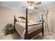 Bedroom featuring a wooden bed frame and patterned window curtains at 2523 Lovette Ln, Graham, NC 27253