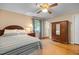 Comfortable bedroom featuring a wooden bed frame, hardwood floors and a ceiling fan at 2523 Lovette Ln, Graham, NC 27253