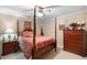 Well-decorated bedroom showcasing a four-poster bed, ceiling fan and coordinated furnishings at 2523 Lovette Ln, Graham, NC 27253