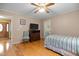 Bright bedroom with hardwood floors, simple decor, and a ceiling fan at 2523 Lovette Ln, Graham, NC 27253