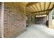 Brick-covered patio with a porch swing, ideal for outdoor relaxation and enjoying the scenery at 2523 Lovette Ln, Graham, NC 27253