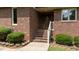 Close up view of the front door with brick steps and well-maintained landscaping with green bushes at 2523 Lovette Ln, Graham, NC 27253