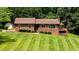 Charming brick home with a manicured lawn and mature trees providing a serene and private setting at 2523 Lovette Ln, Graham, NC 27253