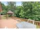A cozy gazebo located on a spacious deck, offering a peaceful spot to enjoy the surrounding lush greenery at 2523 Lovette Ln, Graham, NC 27253