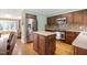 Well-lit kitchen with stainless steel refrigerator and a center island blends seamlessly into the inviting living spaces at 2523 Lovette Ln, Graham, NC 27253