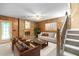 Living room with wood paneling, stone fireplace, and comfortable seating at 2523 Lovette Ln, Graham, NC 27253