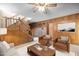 Living room with wood paneling, staircase, skylight and seating at 2523 Lovette Ln, Graham, NC 27253