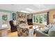 Cozy living room features a stone fireplace, hardwood floors, and large windows for natural light and backyard views at 2523 Lovette Ln, Graham, NC 27253