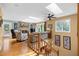 Bright living room boasts a stone fireplace, skylights, and hardwood floors with easy access to an outdoor deck at 2523 Lovette Ln, Graham, NC 27253