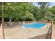 Enjoyable in-ground pool with diving board, complemented by a spacious deck with table and chairs at 2523 Lovette Ln, Graham, NC 27253