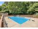 Beautiful in-ground pool surrounded by mature trees and a fenced yard, great for outdoor enjoyment at 2523 Lovette Ln, Graham, NC 27253