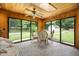 Inviting sunroom with brick floors, wood paneling, skylights, and backyard views at 2523 Lovette Ln, Graham, NC 27253
