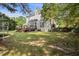Spacious backyard featuring a wooden deck, mature trees, and partial fencing at 3013 Brassfield Dr, Rocky Mount, NC 27803