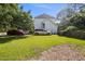 Backyard view of house with driveway, grass, cars and trashcans at 3013 Brassfield Dr, Rocky Mount, NC 27803