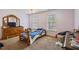 Cozy bedroom featuring light pink walls, carpeted floors, and two windows offering plenty of natural light at 3013 Brassfield Dr, Rocky Mount, NC 27803