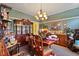 Traditional dining room with a wooden table, matching chairs, and dark wooden display cabinet at 3013 Brassfield Dr, Rocky Mount, NC 27803