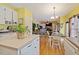 Well-lit kitchen featuring white cabinets, laminate countertops and view to the living room at 3013 Brassfield Dr, Rocky Mount, NC 27803