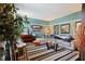 Comfortable living room featuring a gray sofa, striped rug, piano, and light blue walls at 3013 Brassfield Dr, Rocky Mount, NC 27803