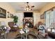 Cozy living room with built-in cabinets, brick fireplace, ceiling fan, and lots of decor at 3013 Brassfield Dr, Rocky Mount, NC 27803