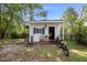 View of the exterior of a white outbuilding with blue shutters and washer/dryer on the porch at 3013 Brassfield Dr, Rocky Mount, NC 27803