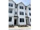 Modern townhome with a white exterior, black window frames, and a well-manicured front yard at 3103 White Blossom Ct, Raleigh, NC 27610