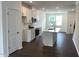 Open-concept kitchen featuring modern appliances, a center island, and white cabinets at 3103 White Blossom Ct, Raleigh, NC 27610