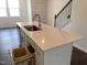 A kitchen island with a sink, quartz countertop and a pull out trashcan at 3103 White Blossom Ct, Raleigh, NC 27610