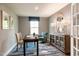 Stylish home office with a work desk, comfortable chair, cabinet for storage and natural light at 318 Rothbury Ct, Sanford, NC 27330
