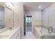 Luxurious bathroom with double vanity, granite counters, soaking tub and glass shower at 3193 Mission Olive Pl # 351, New Hill, NC 27562