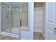 Bathroom with tiled shower, glass door, and wire shelving at 321 Westgrove Ct, Durham, NC 27703