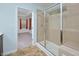 Bright bathroom featuring a tiled shower with glass door and view into bedroom at 321 Westgrove Ct, Durham, NC 27703