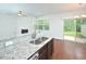 Open-concept kitchen with granite countertops, a breakfast bar, stainless steel appliances and modern fixtures at 321 Westgrove Ct, Durham, NC 27703