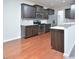 Modern kitchen featuring dark cabinets, stainless steel appliances, and light-colored countertops at 321 Westgrove Ct, Durham, NC 27703