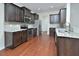 Beautiful kitchen with granite countertops, stainless appliances, and dark wood cabinetry offers style and functionality at 321 Westgrove Ct, Durham, NC 27703