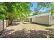 Overview of backyard showing grass area, wood fence, and small deck at 3216 Idlewood Village Dr, Raleigh, NC 27610