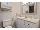 Well-lit bathroom with marble vanity, white cabinets, mirror, and updated fixtures at 3216 Idlewood Village Dr, Raleigh, NC 27610