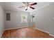 Comfortable bedroom with hardwood floors, ceiling fan, and mirrored closet doors at 3216 Idlewood Village Dr, Raleigh, NC 27610