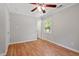 Bedroom with hardwood floors, neutral paint, ceiling fan, and ample natural light at 3216 Idlewood Village Dr, Raleigh, NC 27610