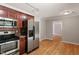 Modern kitchen with stainless steel appliances and view into adjacent living space at 3216 Idlewood Village Dr, Raleigh, NC 27610