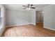 Spacious living room featuring hardwood floors, neutral paint, crown molding, and a ceiling fan at 3216 Idlewood Village Dr, Raleigh, NC 27610