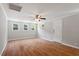 Bright living room offering multiple windows, hardwood floors, and a welcoming atmosphere at 3216 Idlewood Village Dr, Raleigh, NC 27610