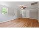 Versatile living room with hardwood floors, neutral tones, and multiple entryways for easy flow at 3216 Idlewood Village Dr, Raleigh, NC 27610