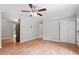 Neutral living room showcasing hardwood floors, crown molding, and a sliding-door closet for storage at 3216 Idlewood Village Dr, Raleigh, NC 27610