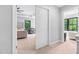 Bright bedroom entrance featuring a glimpse of the main bedroom with ample natural light at 322 Scheer Ave, Durham, NC 27703