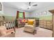 Calming Bedroom with two wooden cribs, rocking chair, dresser, and a soothing color scheme at 322 Scheer Ave, Durham, NC 27703