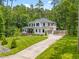 Stunning home with lush green lawn, long driveway, and an attached two car garage at 322 Scheer Ave, Durham, NC 27703