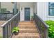 Charming front porch with brick stairs, black railings, and decorative plants at 322 Scheer Ave, Durham, NC 27703